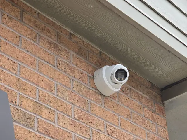 Turret camera on a brick plaza wall under the canopy