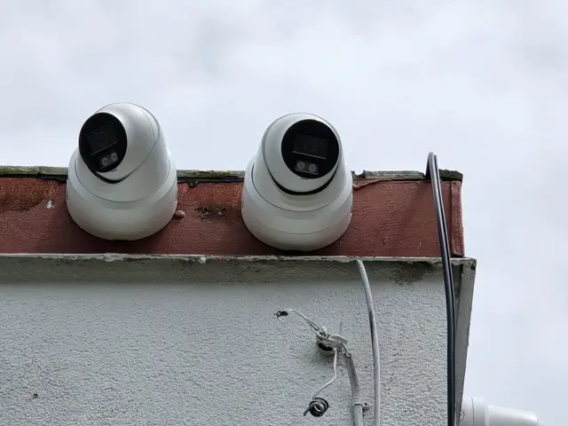 Two turret cameras on a flat roofline