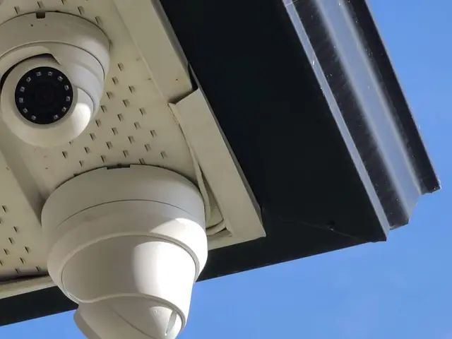 Two cameras under a porch soffit