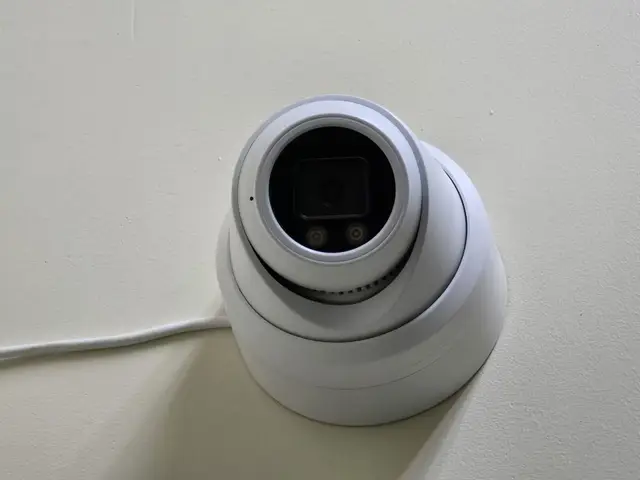 Turret camera mounted high on an interior wall