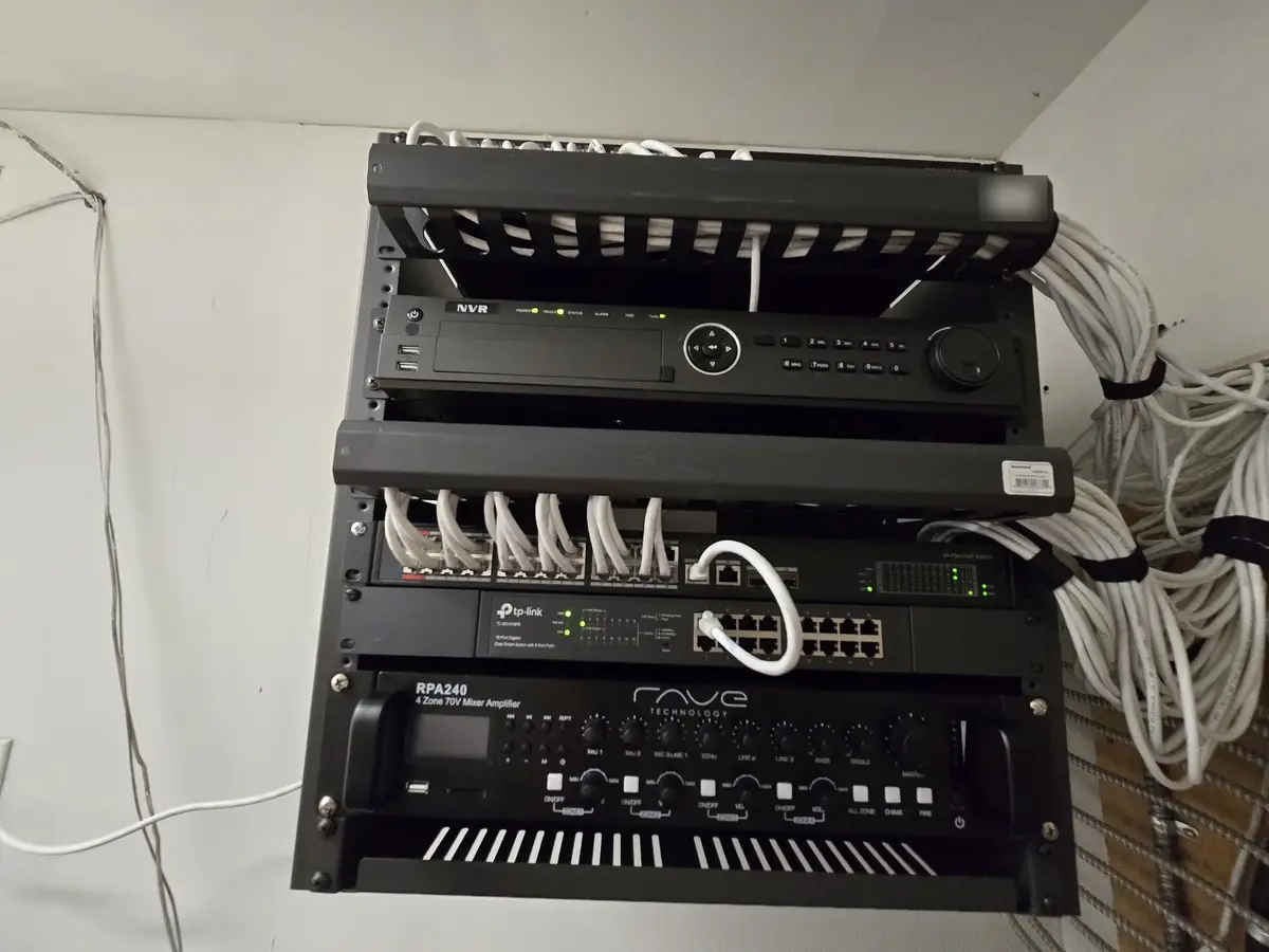 Wall rack with a network video recorder, PoE switch and patch panel
