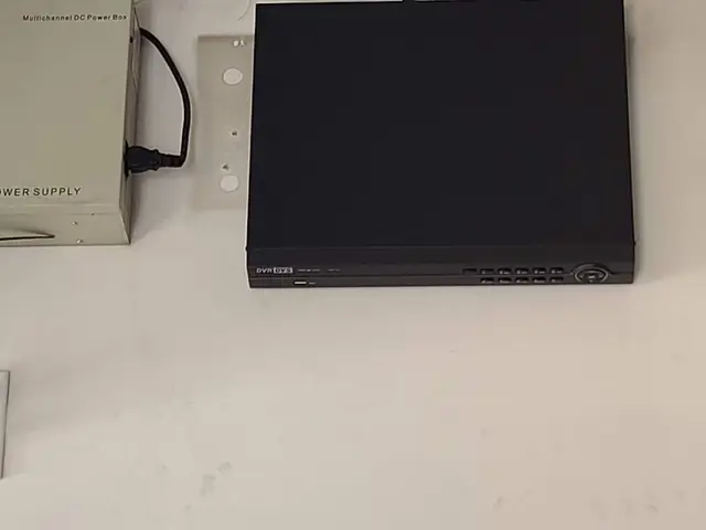 Network video recorder and camera power supply mounted on a utility room wall